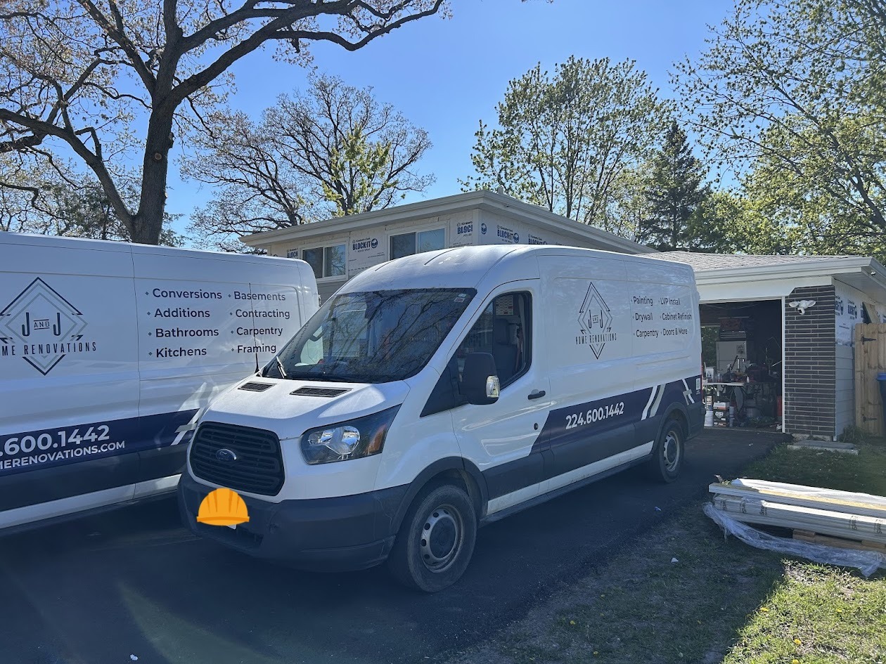 J&J Home Renovations work vans at an active project